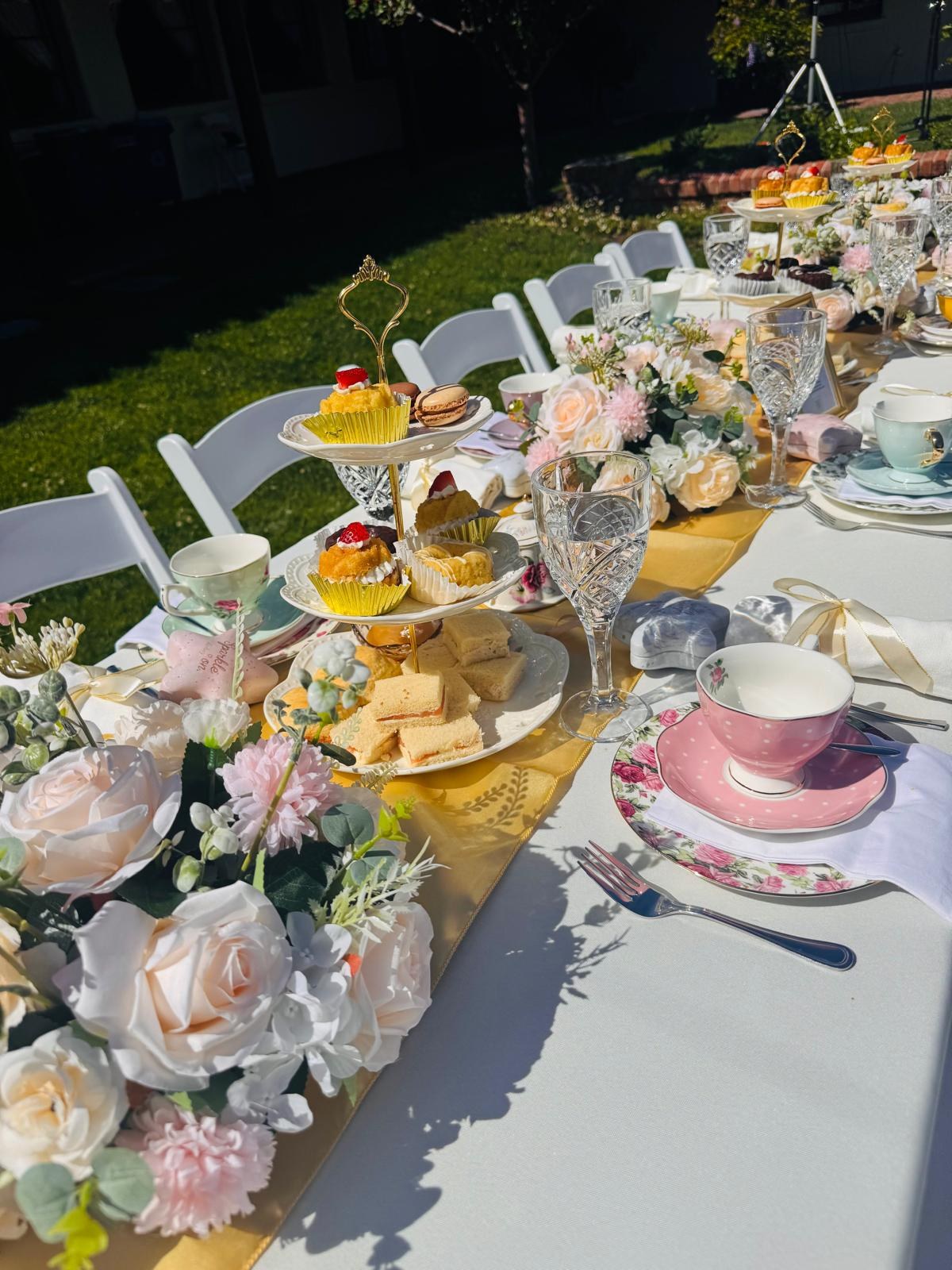 Outdoor tea party table with gold runner